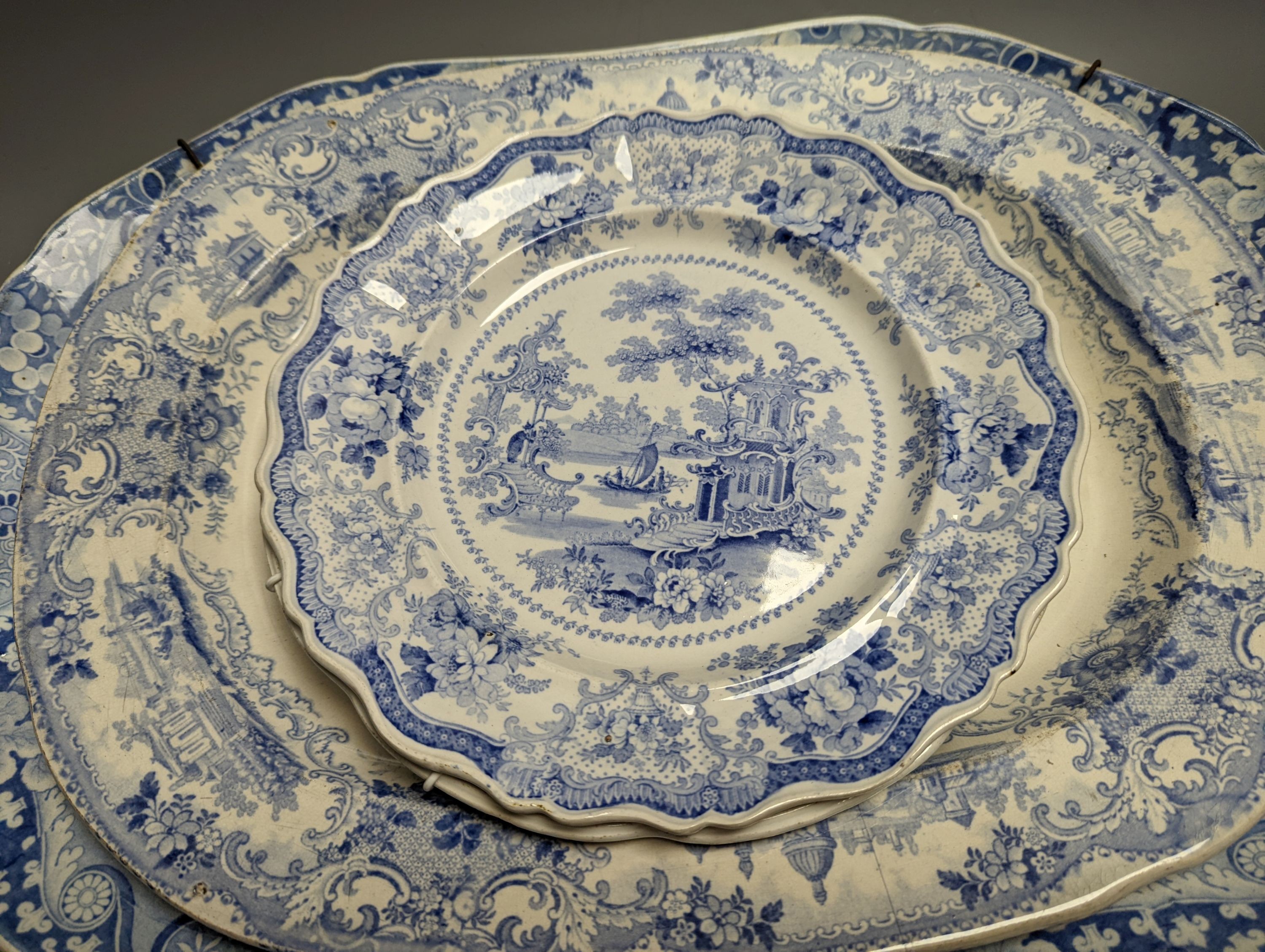 Two 19th century blue and white meat dishes and three similar plates, largest platter 49cms wide